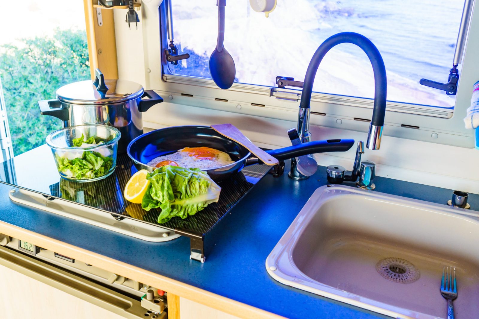 Kitchen Sink And Countertop With Glass Jars Of Food Stock Photo